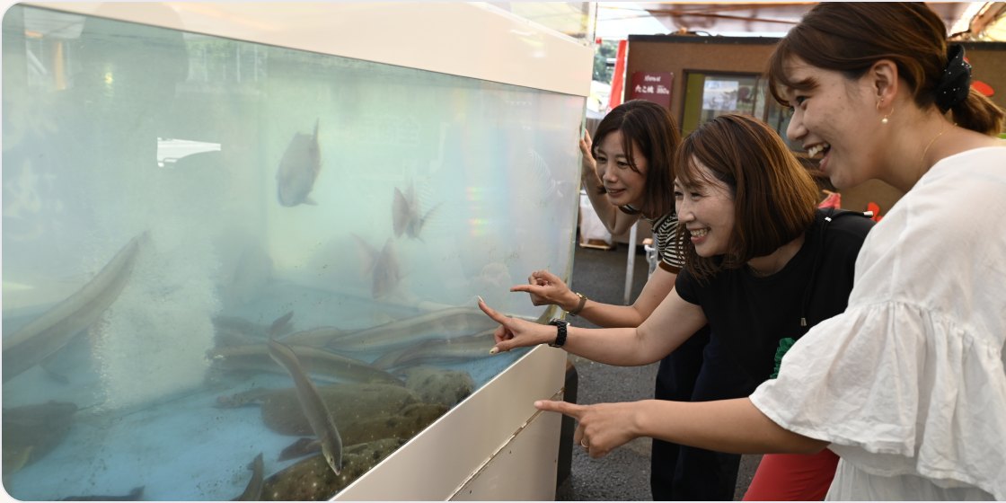 いけすの魚を選ぶお客さま